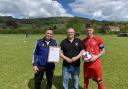 April's team of the month was awarded to Axbridge Utd first team, presented by league official Dave Channing (middle)