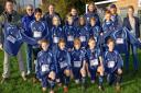 Weston Crusaders U12's team and officials with Charlotte Grant (right) and Andrew Pearce (left) from Somerset Coast YMCA.