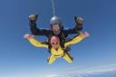 Thumbs up! Wayne Ewing in freefall strapped to skydiver Ryan.