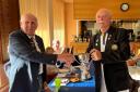 Winscombe captain Geoff Coombe receives the over-55s Knockout Cup from chairman Wilf Ainsworth.