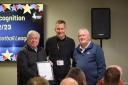 Woodspring Junior League chairman John Major and secretary Dave Gooding receive the League Recognition Award from the Somerset FA.