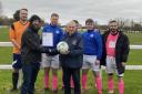 Highburn Athletic receive the November Team of the Month award from Weston & District League Official Andy Jay.