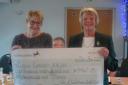 Wedmore Golf Club's Helen Tanswell presents a cheque of £9,000 to Cancer Research.