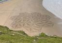 Artist Simon Beck created a thank you sand mural at Brean Cove beach yesterday (Monday).