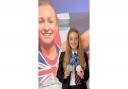Macy Noad pictured underneath Heptathlon Champion Dame Jessica Ennis-Hill at The King Alfred School Academy in their 40-foot giant photographic inspirational tribute with her silver medals.