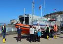 Christine and Thomas Dunstone, and their sons Richard and Edward from 1st Milton Scouts, with members of Weston RNLI.