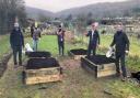 Rotarians and volunteers from SPACE charity working on the allotment in Cheddar.