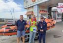 Rotarian George Horsfield with RNLI volunteers outside The Grand Pier.
