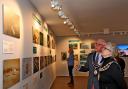 Mayor Cllr Sonia Russe and consort David Ray inspect the award-winning pictures at Weston Museum.