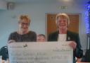 Wedmore Golf Club's Helen Tanswell presents a cheque of £9,000 to Cancer Research.