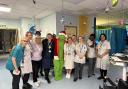The Grinch spreads Christmas cheer to patients and staff.