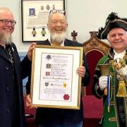 Michael Eavis receives the Freeman of Glastonbury title from mayor Jon Cousins and town crier, David Greenway