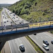 Extinction Rebellion members from Portishead, Clevedon and Pill dropped banners with climate warnings over traffic heading into North Somerset.