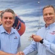 Outgoing lifeboat operations manager, Mike Buckland (R), handing the station keys to the newly appointed manager, Chris Ware, outside Weston RNLI station at Knightstone.