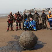 The old buoy was first thought to be a World War Two era sea mine. Weston Coastguard and explosive ordnance disposal teams at Plymouth are pictured in front of the suspicious device.