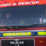 A man in his X was taken to hospital after a fire broke out in a shop below his home.