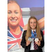 Macy Noad pictured underneath Heptathlon Champion Dame Jessica Ennis-Hill at The King Alfred School Academy in their 40-foot giant photographic inspirational tribute with her silver medals.