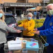 Cheddar Lions President Keith with Lions Lyn and Sylvia presenting the devices to Maria at Weston General's car park.