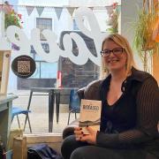 Steph Hurne (S.M. Thomas) pictured with her new book The Diseased at Loves Cafe in Weston.