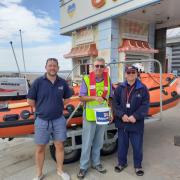 Rotarian George Horsfield with RNLI volunteers outside The Grand Pier.