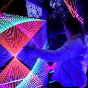 A GLOW Festival visitor experiences Bev G Star's Entwined installation.