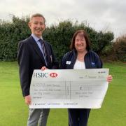 Weston Golf Club seniors captain John Whitewood presents the cheque of £3,750 to  RSPCA North Somerset fundraising manager Dawn Pawlett
