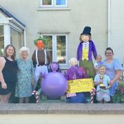 First prize winners who created Charlie and the Chocolate Factory scarecrows.