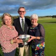 John Whitewood and his wife Alison Whitwood being presenting with the trophy by Sally Irlam.
