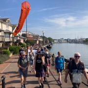 The pilgrims walk along Bristol harbour near the start of their journey.
