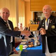 Winscombe captain Geoff Coombe receives the over-55s Knockout Cup from chairman Wilf Ainsworth.