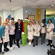 The Grinch spreads Christmas cheer to patients and staff.