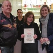 Mike Shaw presenting The Galley cafe with a certificate for best sausage sandwich in the UK.