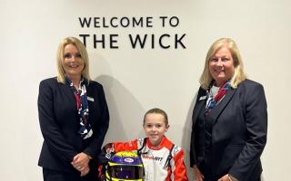 Theo Tyack wearing his new racing kit donated by Bloor Homes with sales team Karen Lyons (left) and Jane Briscoe (right) at The Wick in Weston-super-Mare.